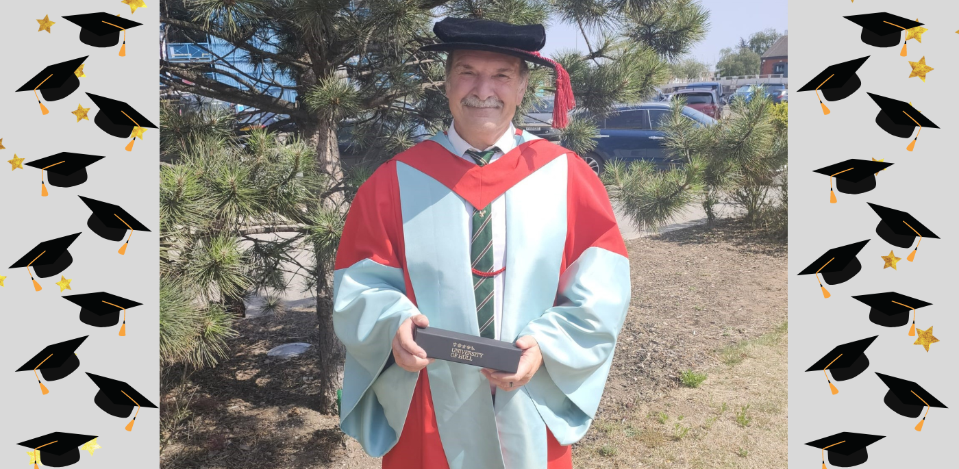 Professor Andy Beavis in his ceremonial robes holding his award