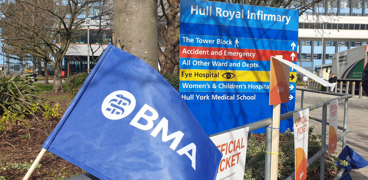 BMA flag and picket sign in front of Hull Royal Infirmary