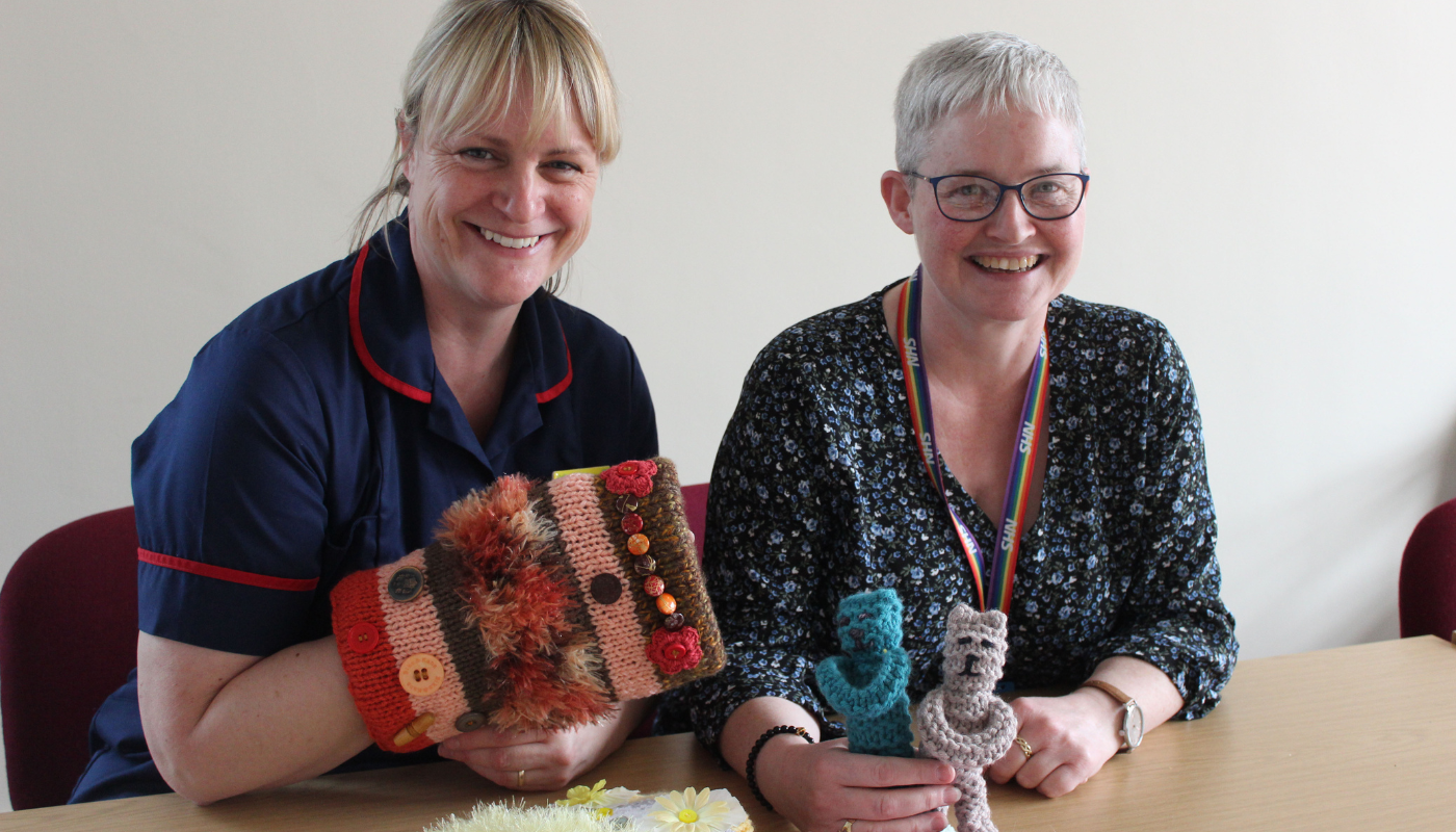 Karen Harrison and Liz Byrne holding some of the knitted donations