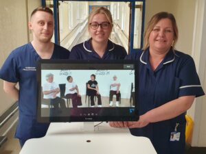 Ward 20 staff standing behind the RITA screen