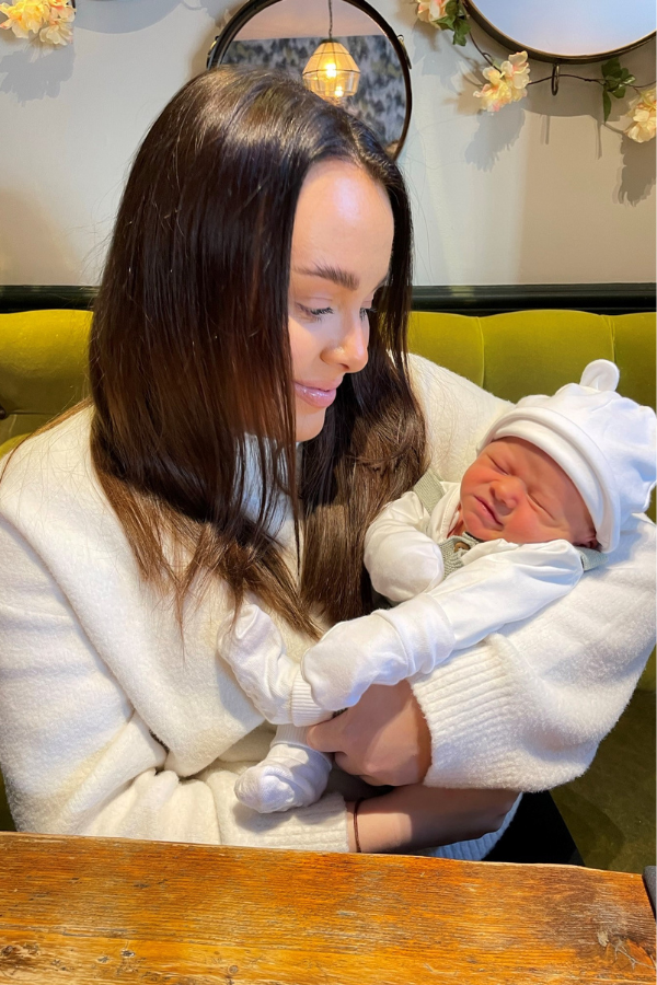 Grace holding baby Billy seated at a table