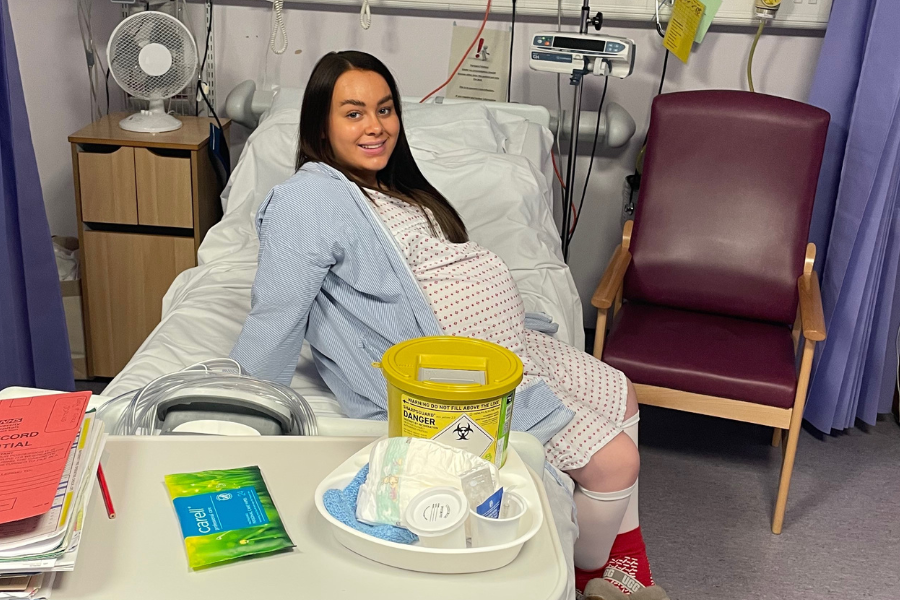 Grace sits on a hospital bed waiting for her caesarean section
