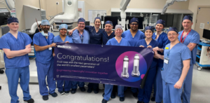 The surgical team which carried out the first leadless pacemaker procedure hold up a celebratory banner