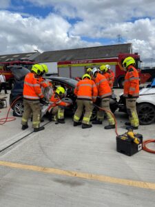 fire fighters around a car wreck