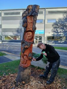 Allen has carved the stump with leaves, an owl and a squirrel