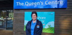 Zowie Fussey in nurse's uniform standing outside the Queen's Centre